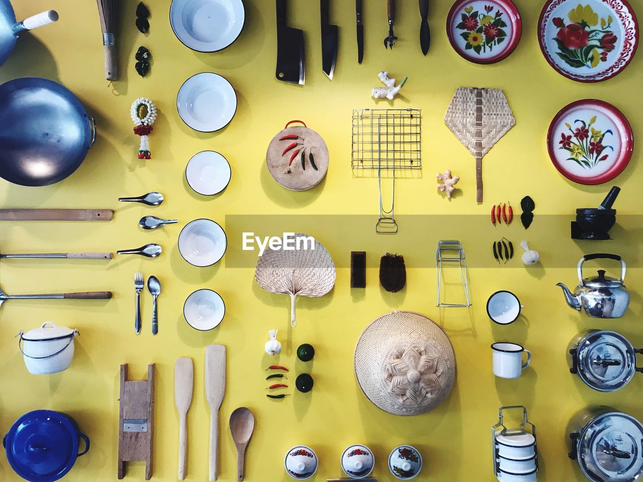 Flat lay of kitchen utensils on yellow background