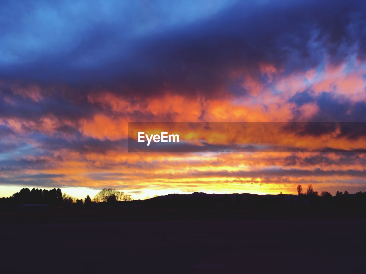 SILHOUETTE LANDSCAPE AGAINST DRAMATIC SKY