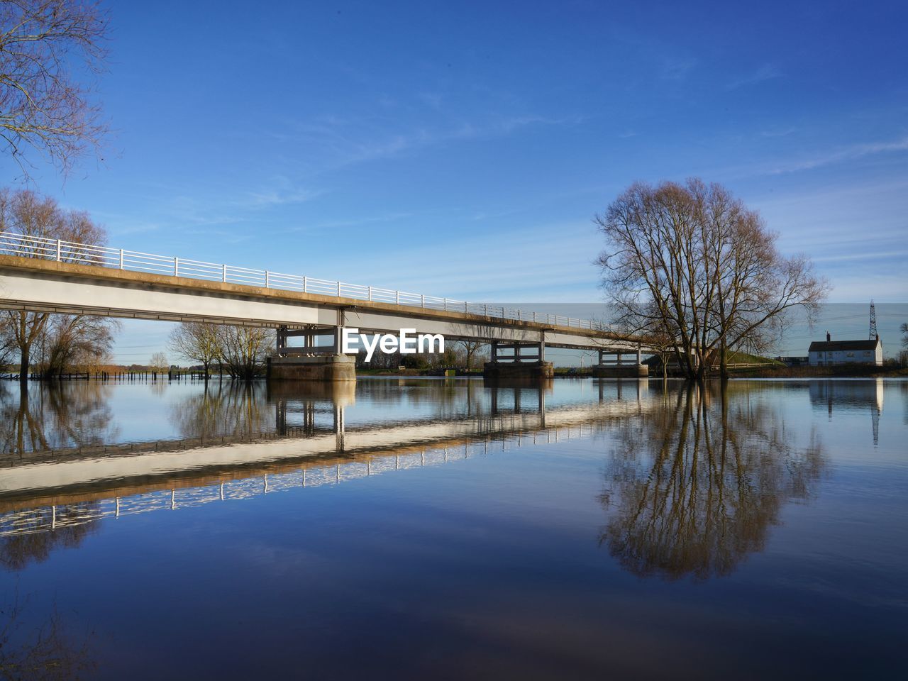 Empty bridge reflected in wide river