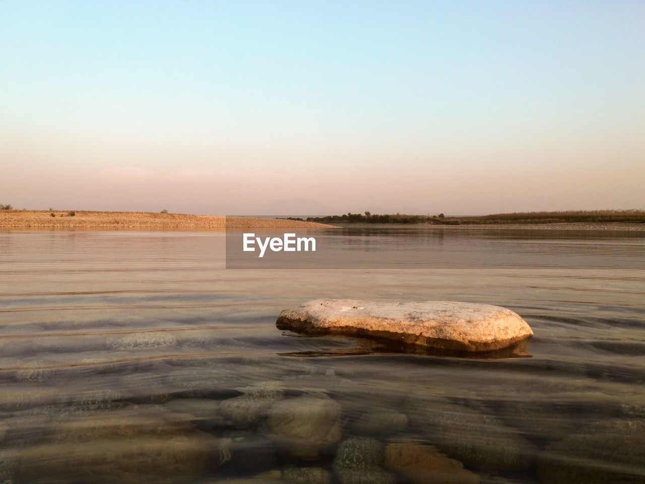 A lonely rock at the center of river indus in winter 