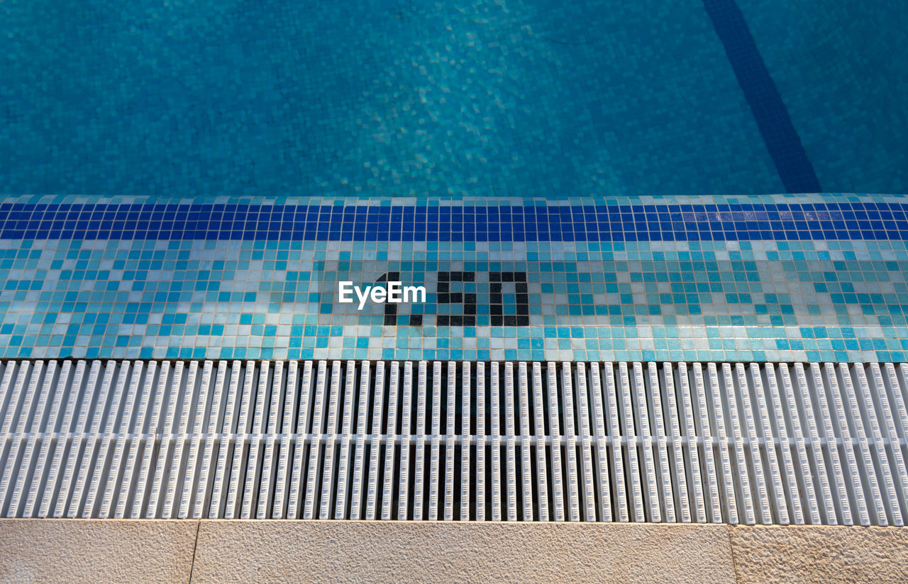 High angle view of numbers on poolside at swimming pool