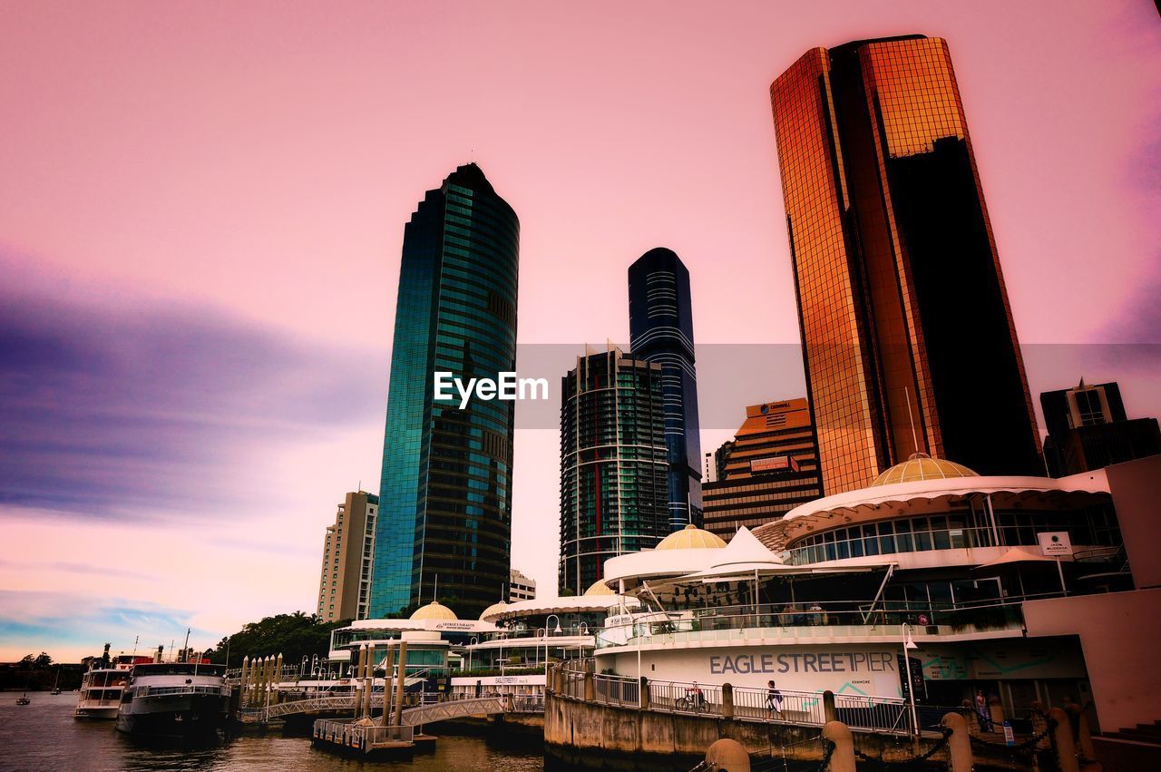 MODERN BUILDINGS AGAINST SKY DURING SUNSET IN CITY