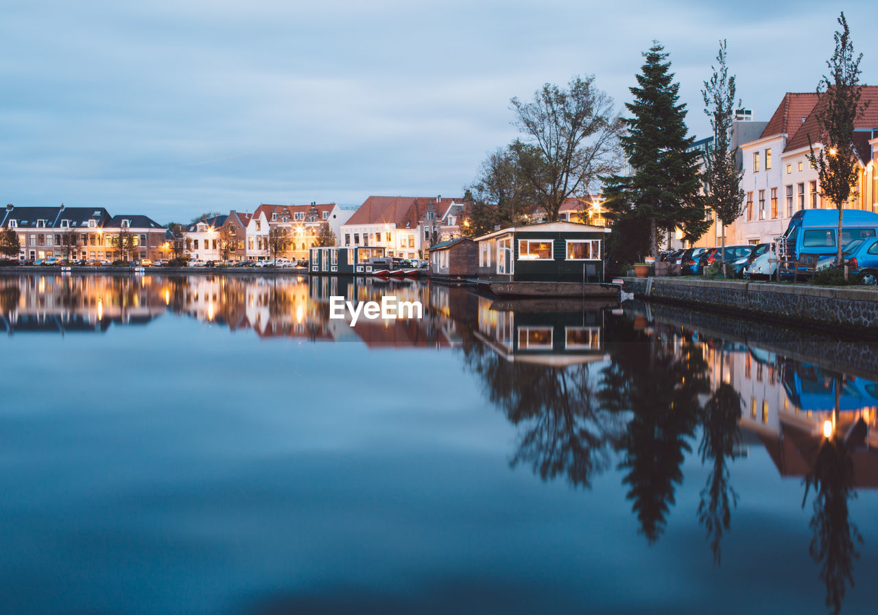 Reflection of houses in town against sky