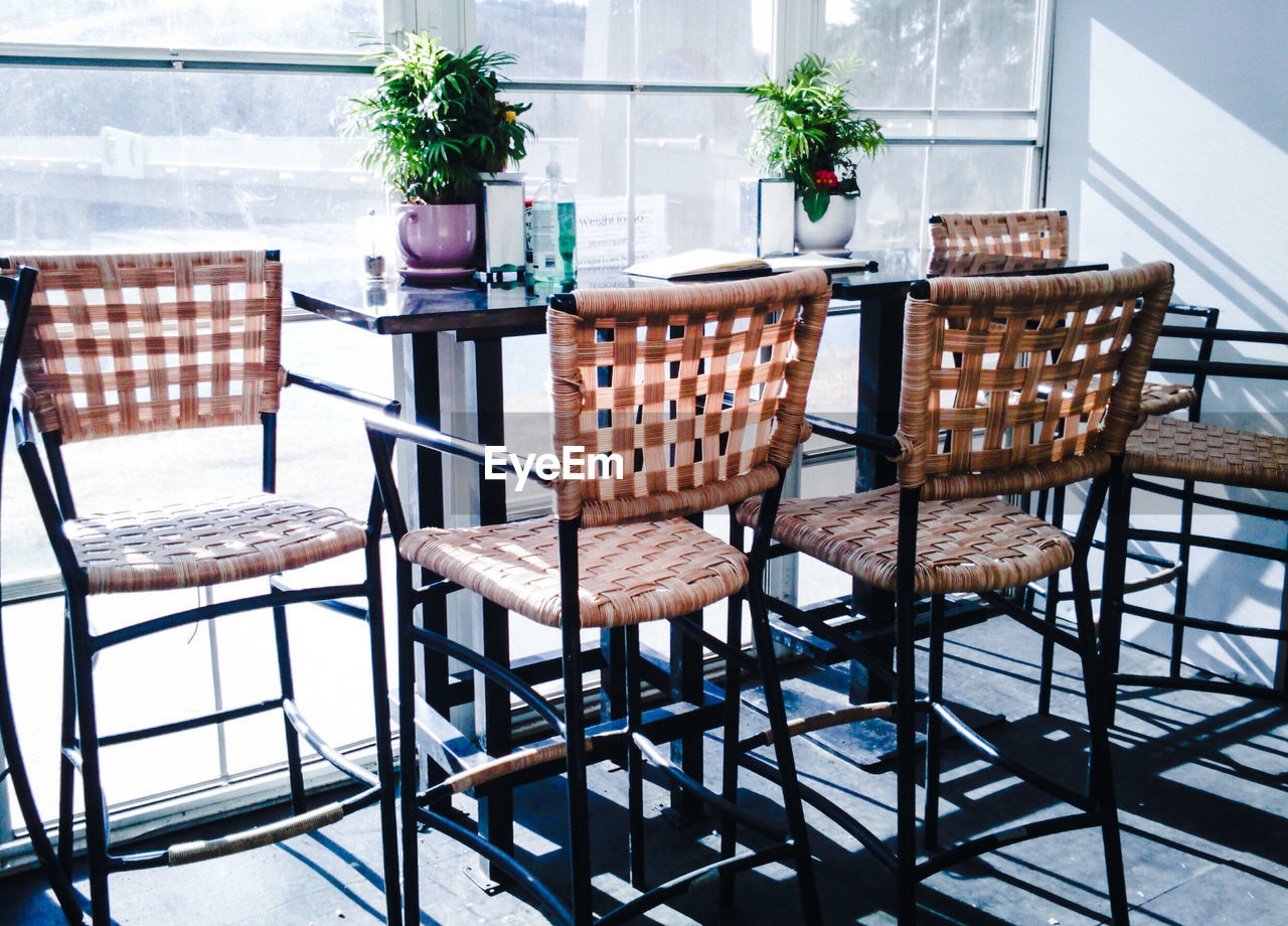 Table and chairs on floor at cafe