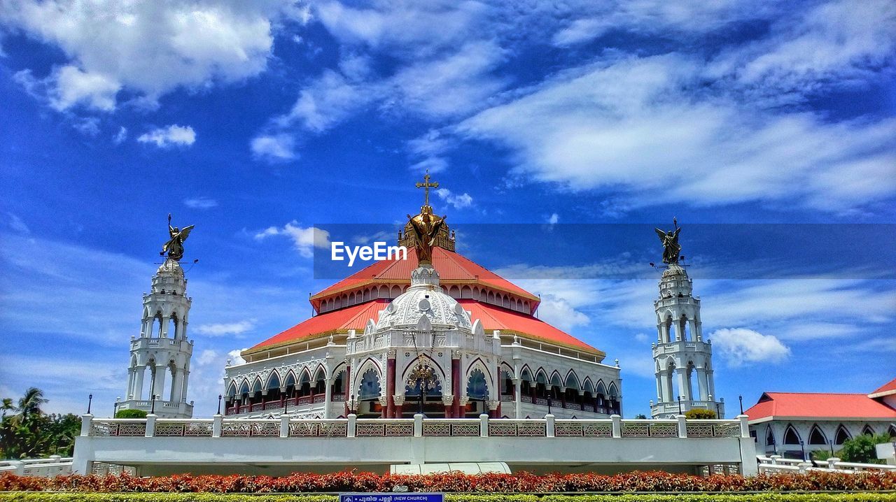 Low angle view of building against cloudy sky