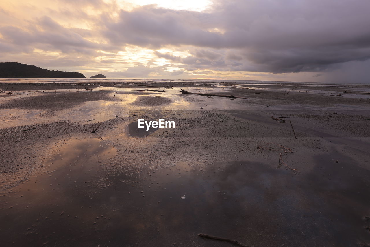 Scenic view of beach against sky during sunset
