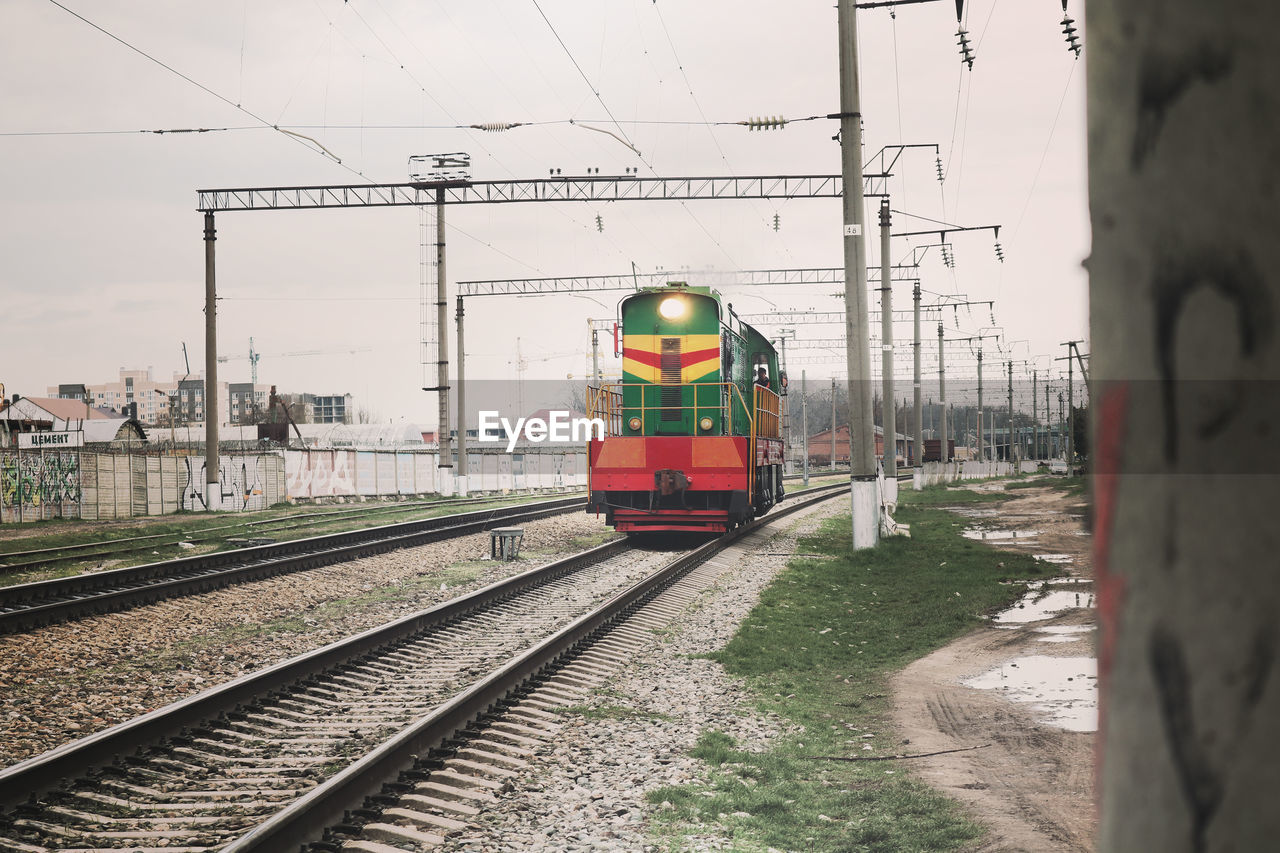 Train at railroad tracks against sky