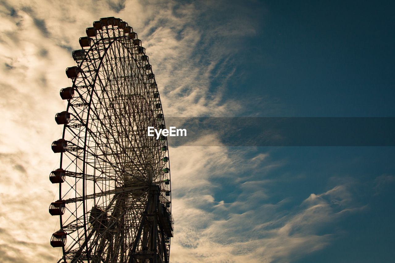 Low angle view of ferris wheel against sky