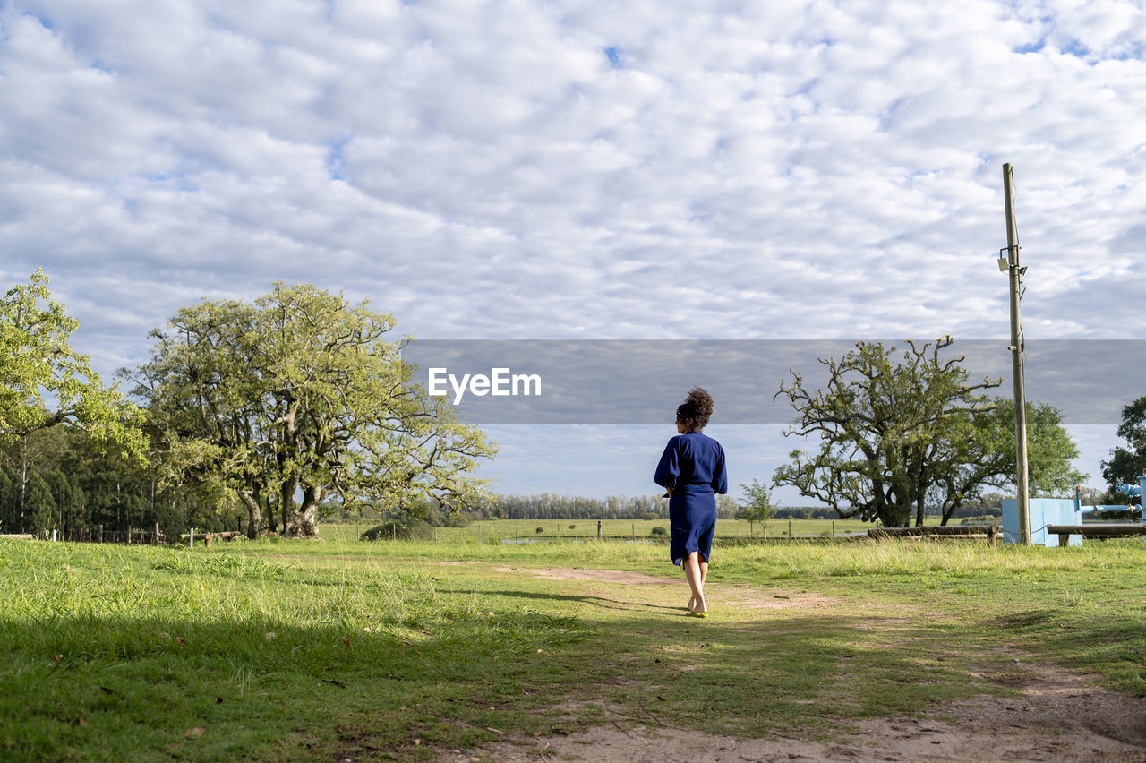 Woman walking outdoors in the field.