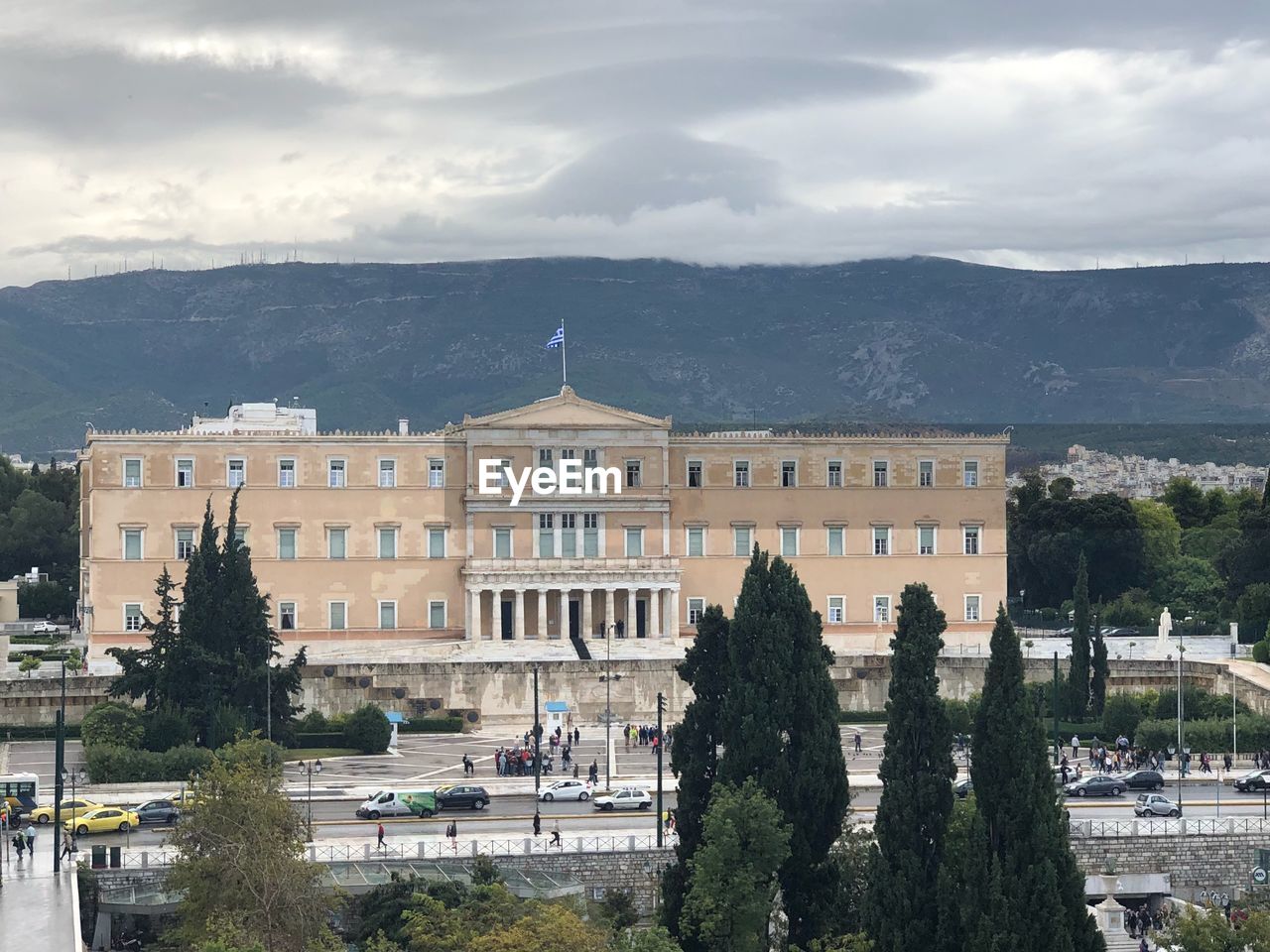 Buildings in city against cloudy sky