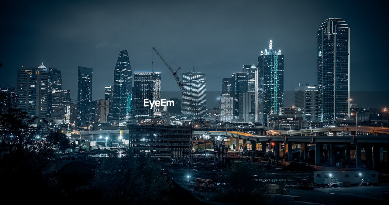 illuminated cityscape against sky at night