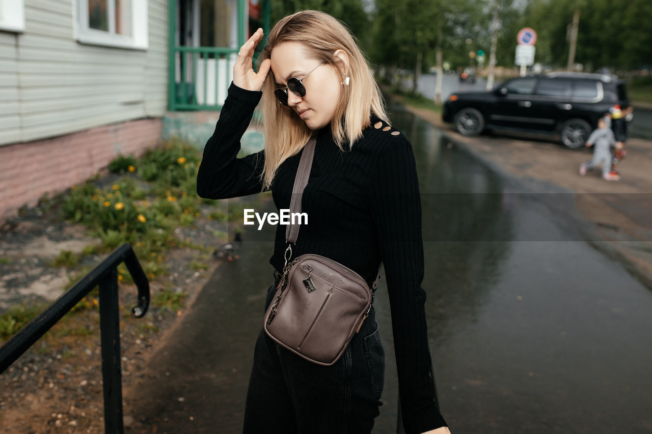 Image of a beautiful cute blonde girl in sunglasses. portrait of a thirty-year-old girl in profile