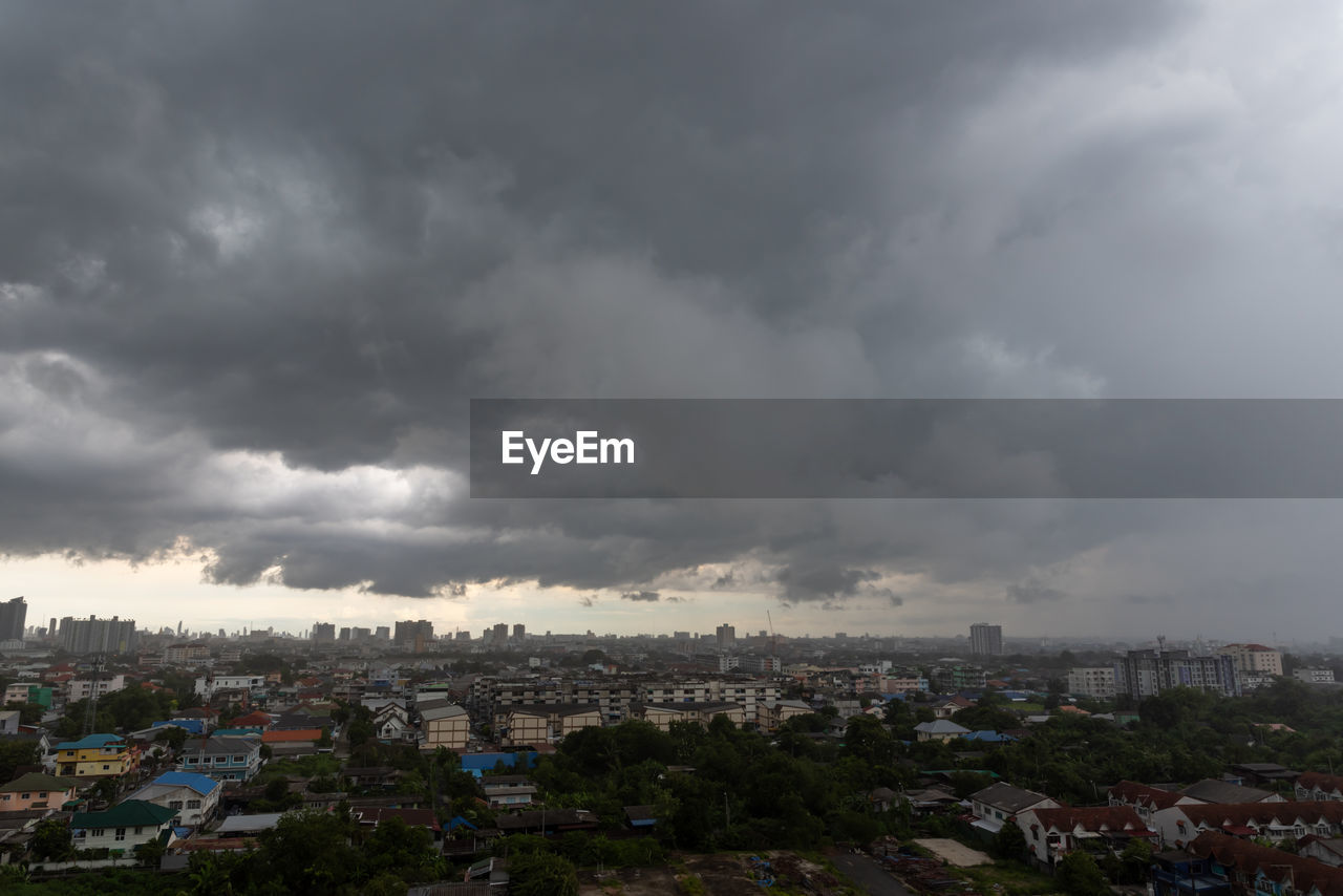 high angle view of cityscape against cloudy sky