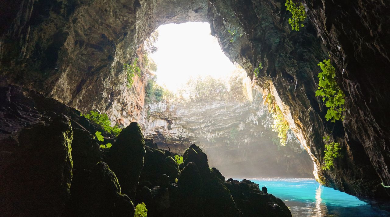 Scenic view of sea seen through cave