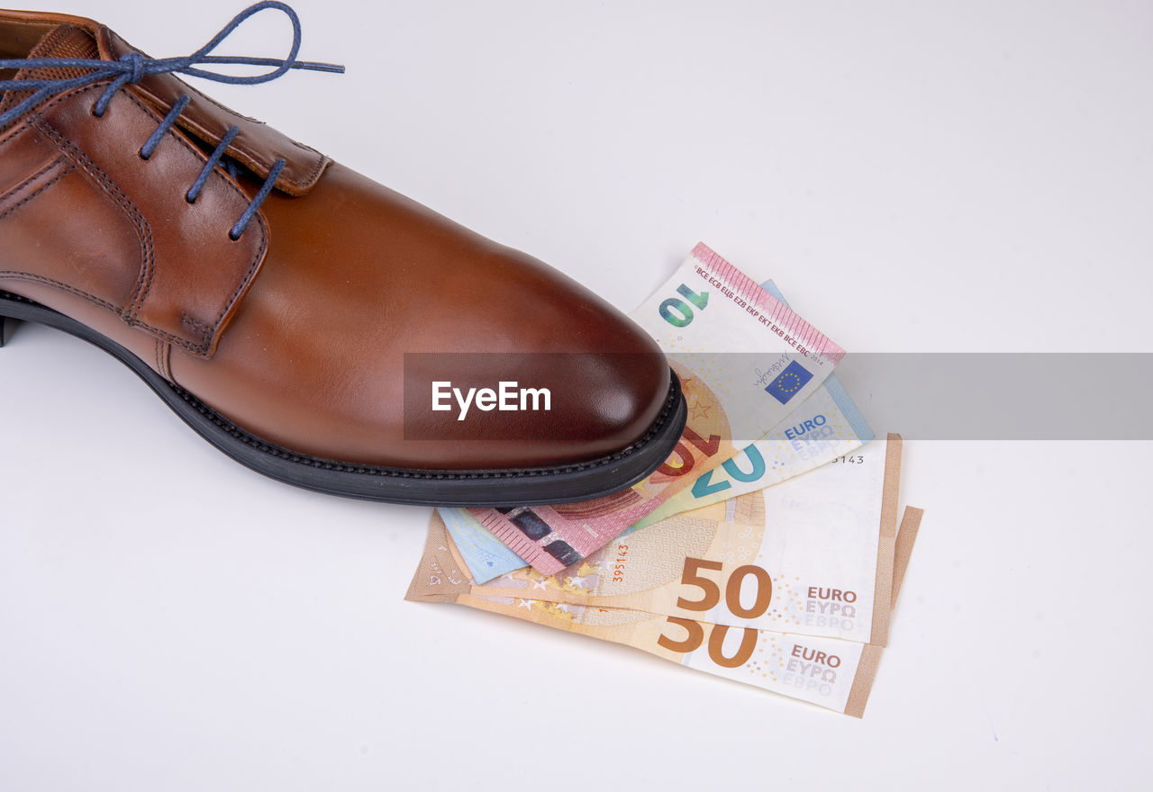 High angle view of shoes and money on table