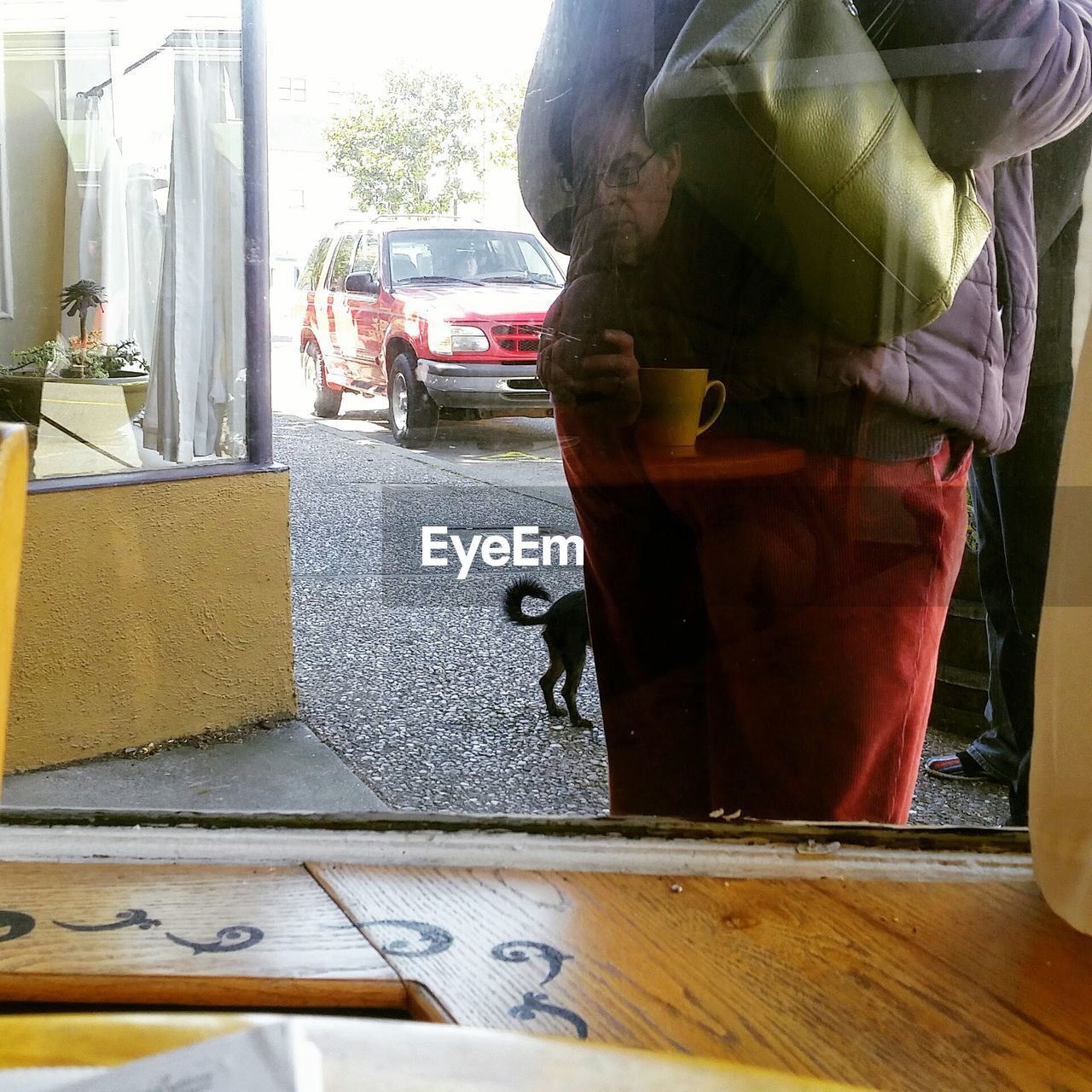 Reflection of man sitting at cafe