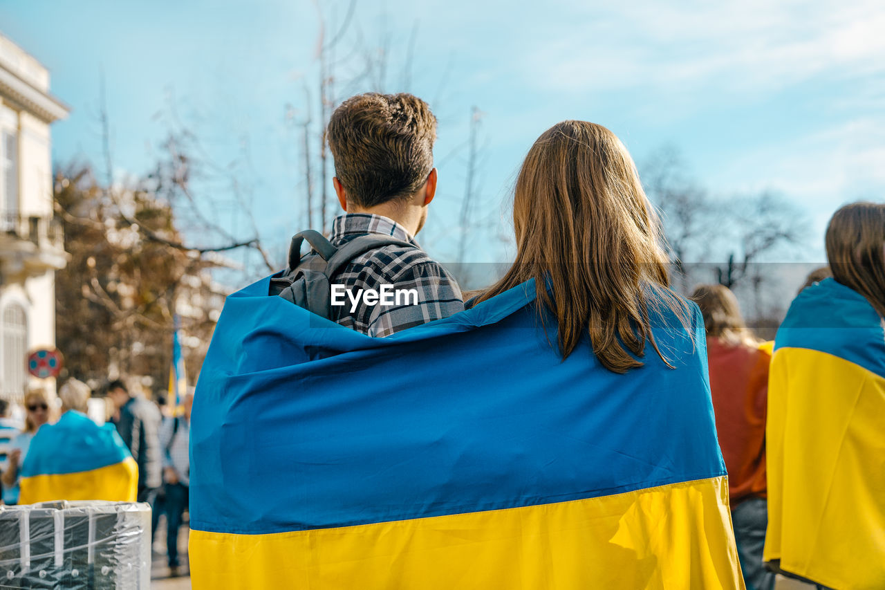 Couple holding ukraine flag at protest