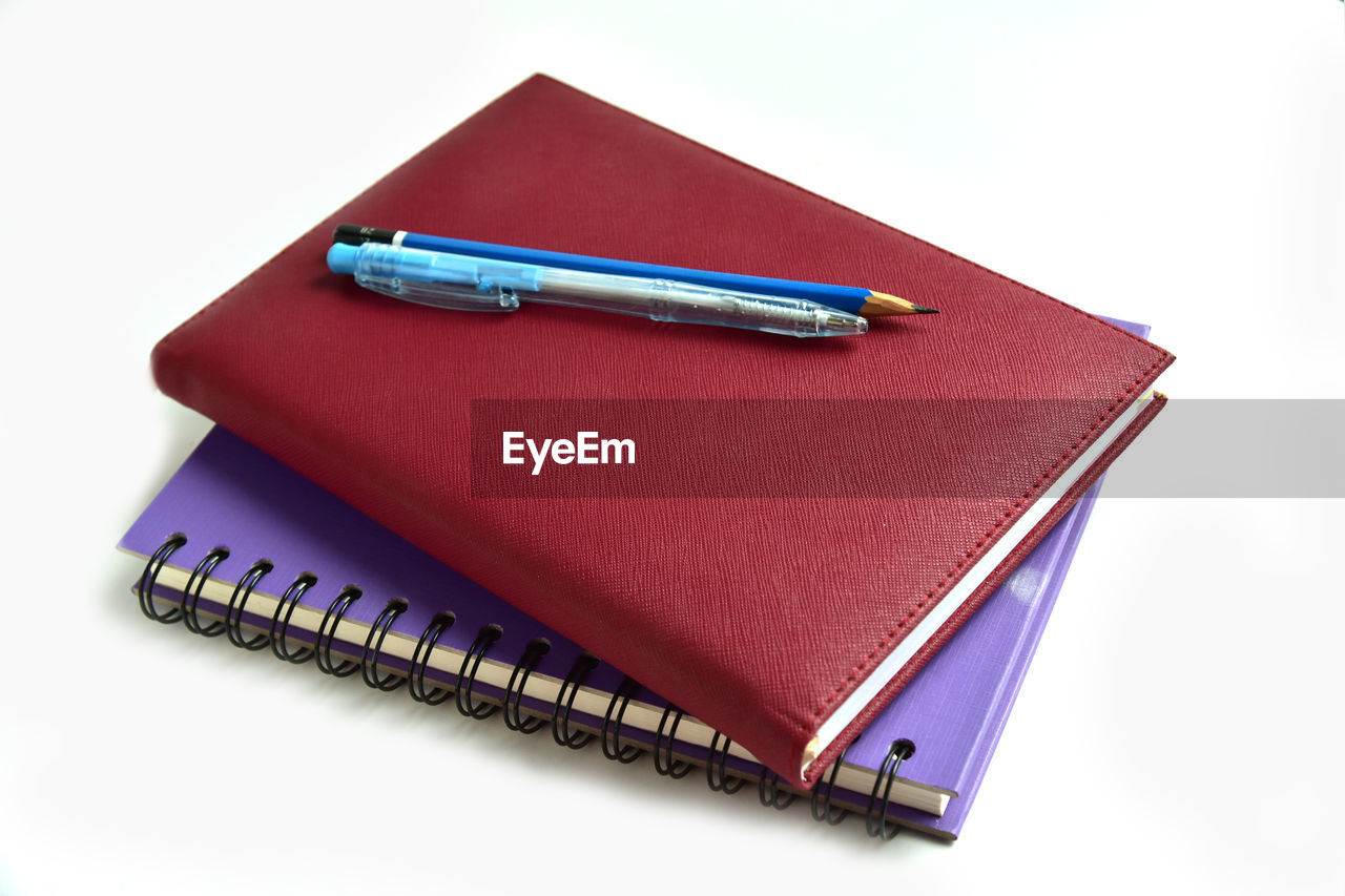 HIGH ANGLE VIEW OF BOOKS IN PEN