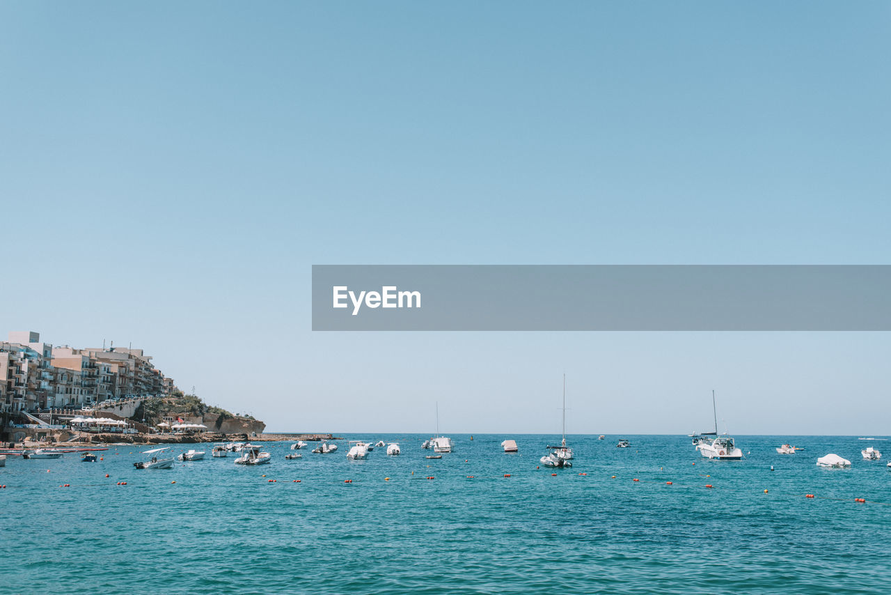 BOATS IN SEA AGAINST CLEAR SKY