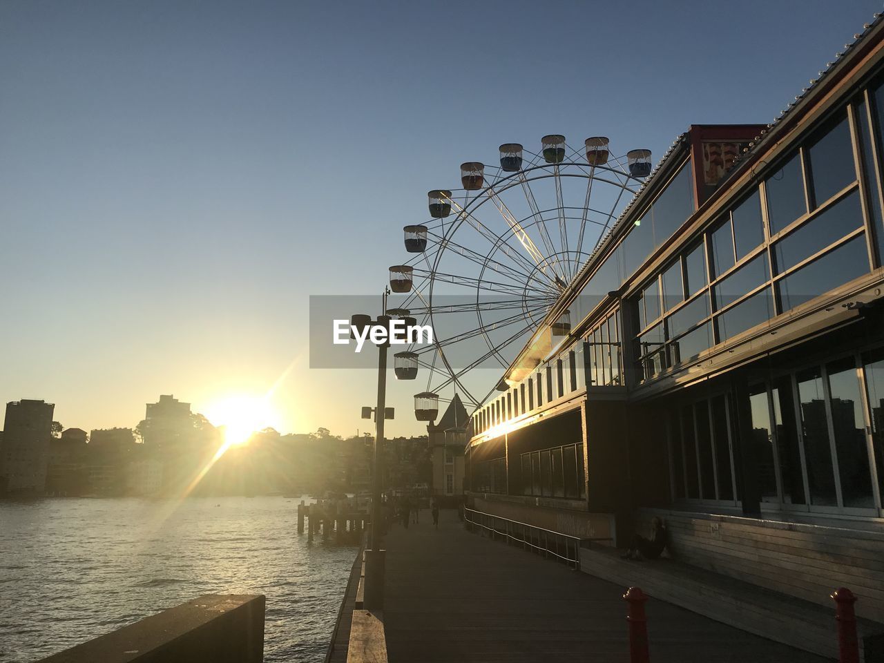 FERRIS WHEEL IN CITY AGAINST CLEAR SKY