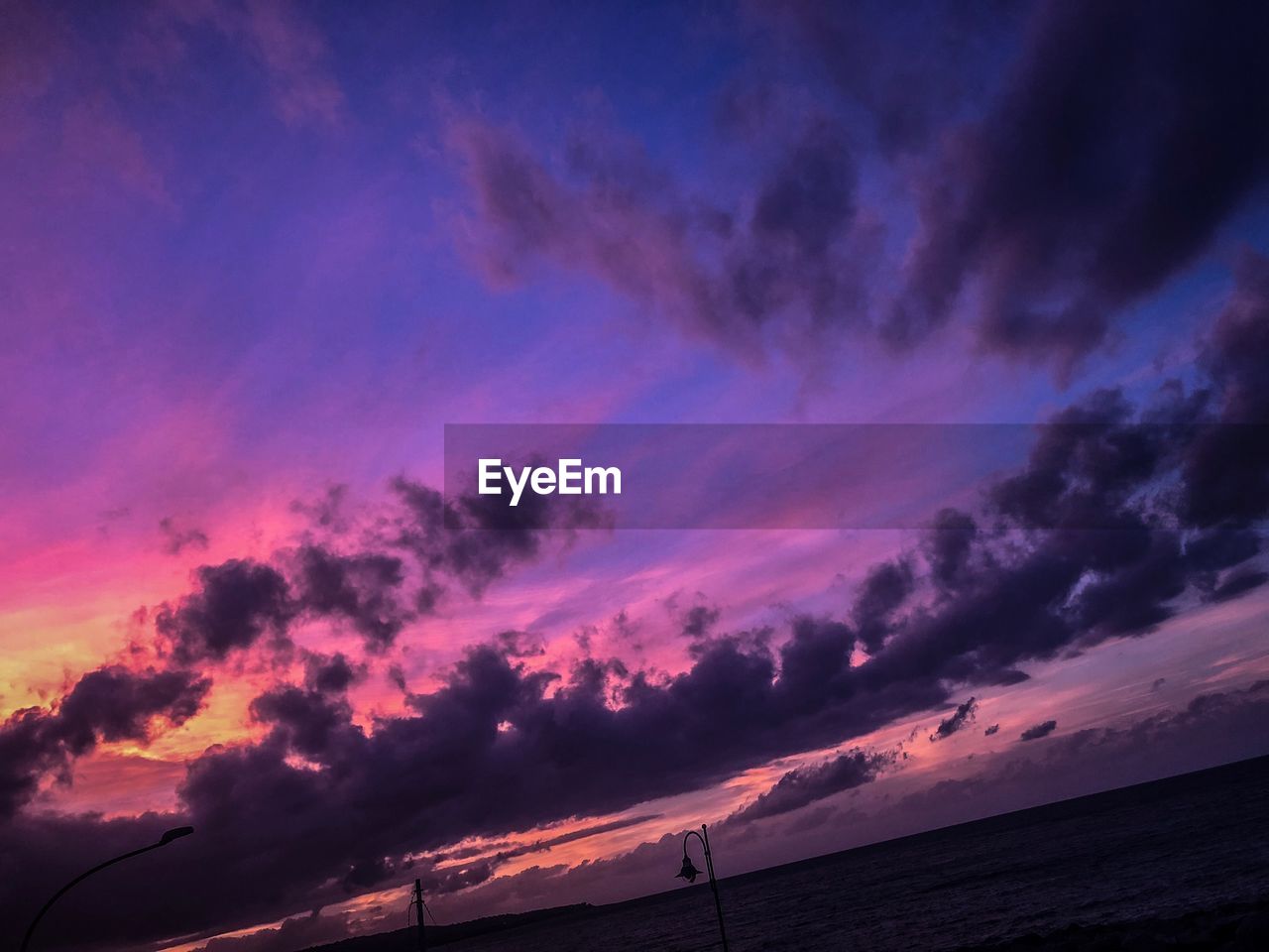 LOW ANGLE VIEW OF DRAMATIC SKY OVER SILHOUETTE LANDSCAPE