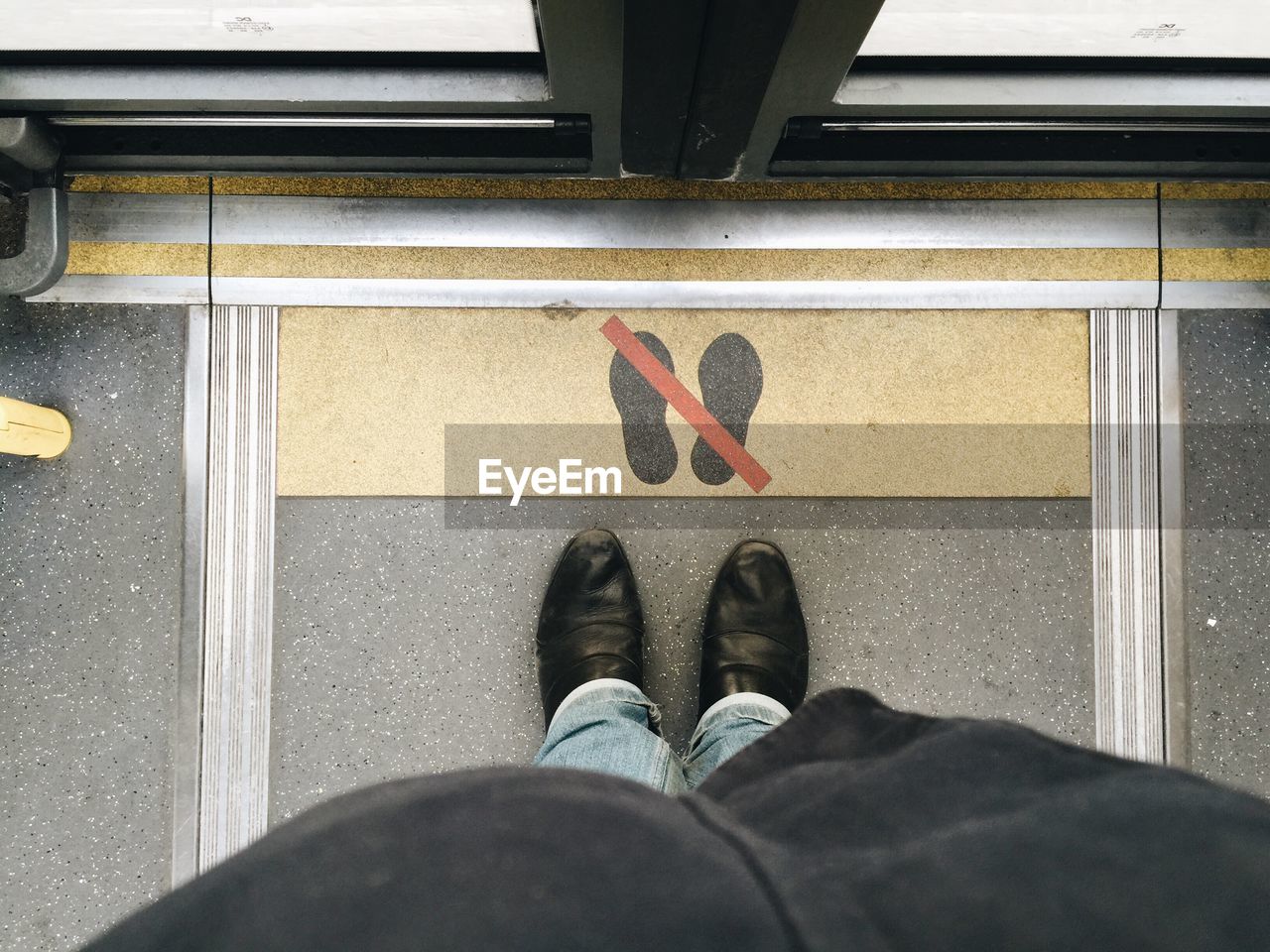 Low section of man standing on floor