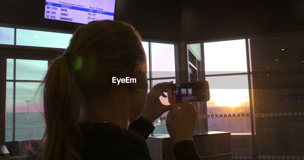 PORTRAIT OF WOMAN PHOTOGRAPHING THROUGH CAMERA