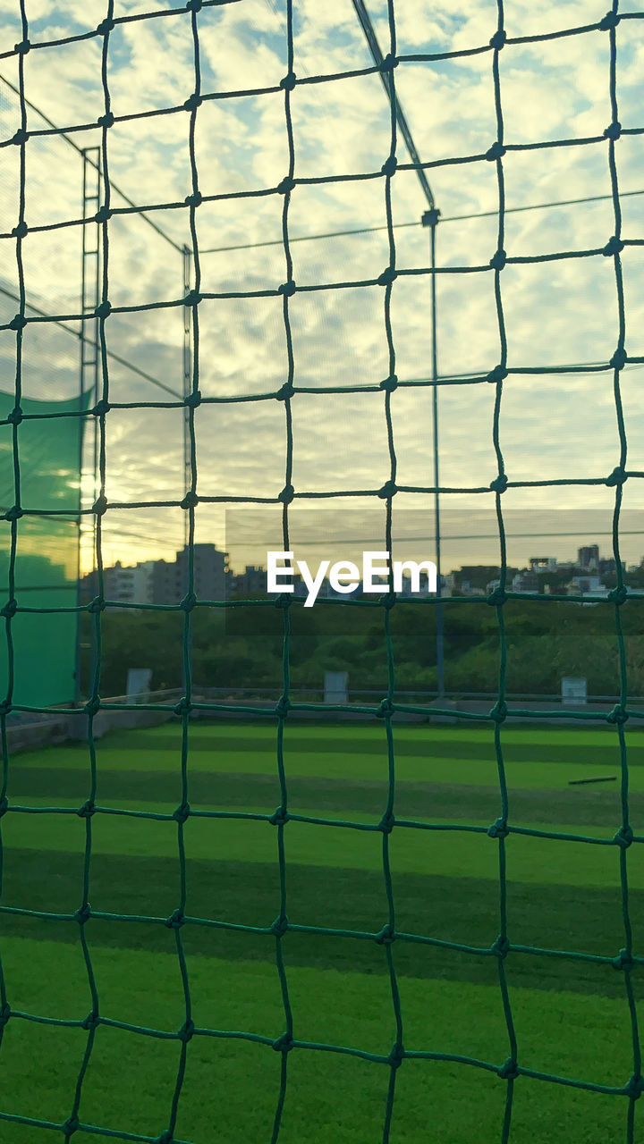 net, sports, grass, green, nature, no people, sunlight, sky, soccer, chain-link fencing, reflection, plant, fence, soccer field, field, day, cloud, team sport, outdoors, line, land, full frame, pattern, outdoor structure, stadium, playing field, net - sports equipment, sport venue, backgrounds, security