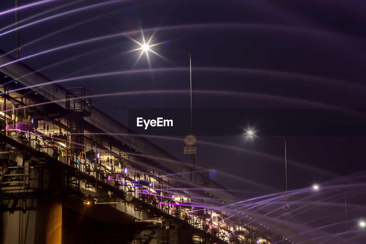 Low angle view of fountains on illuminated banpo bridge at night