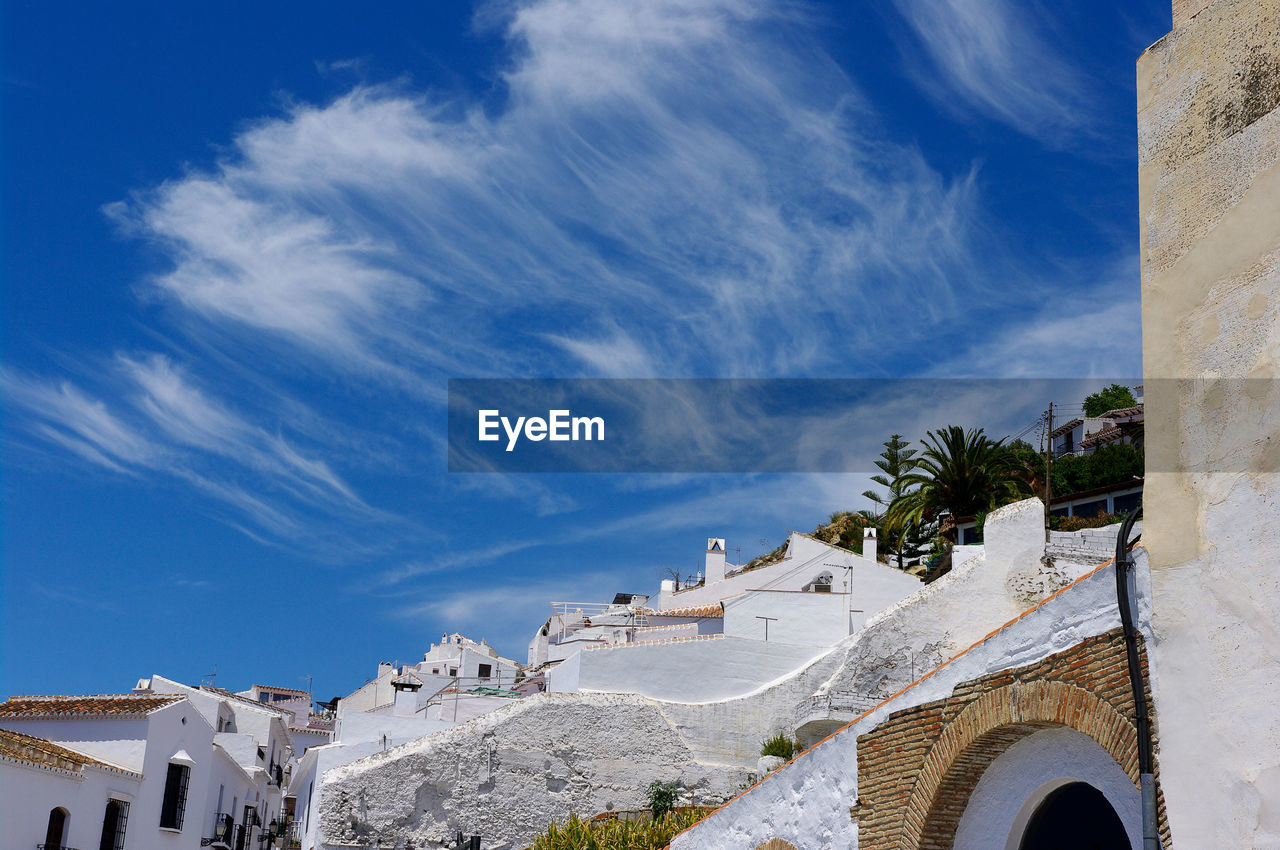 Low angle view of buildings against blue sky