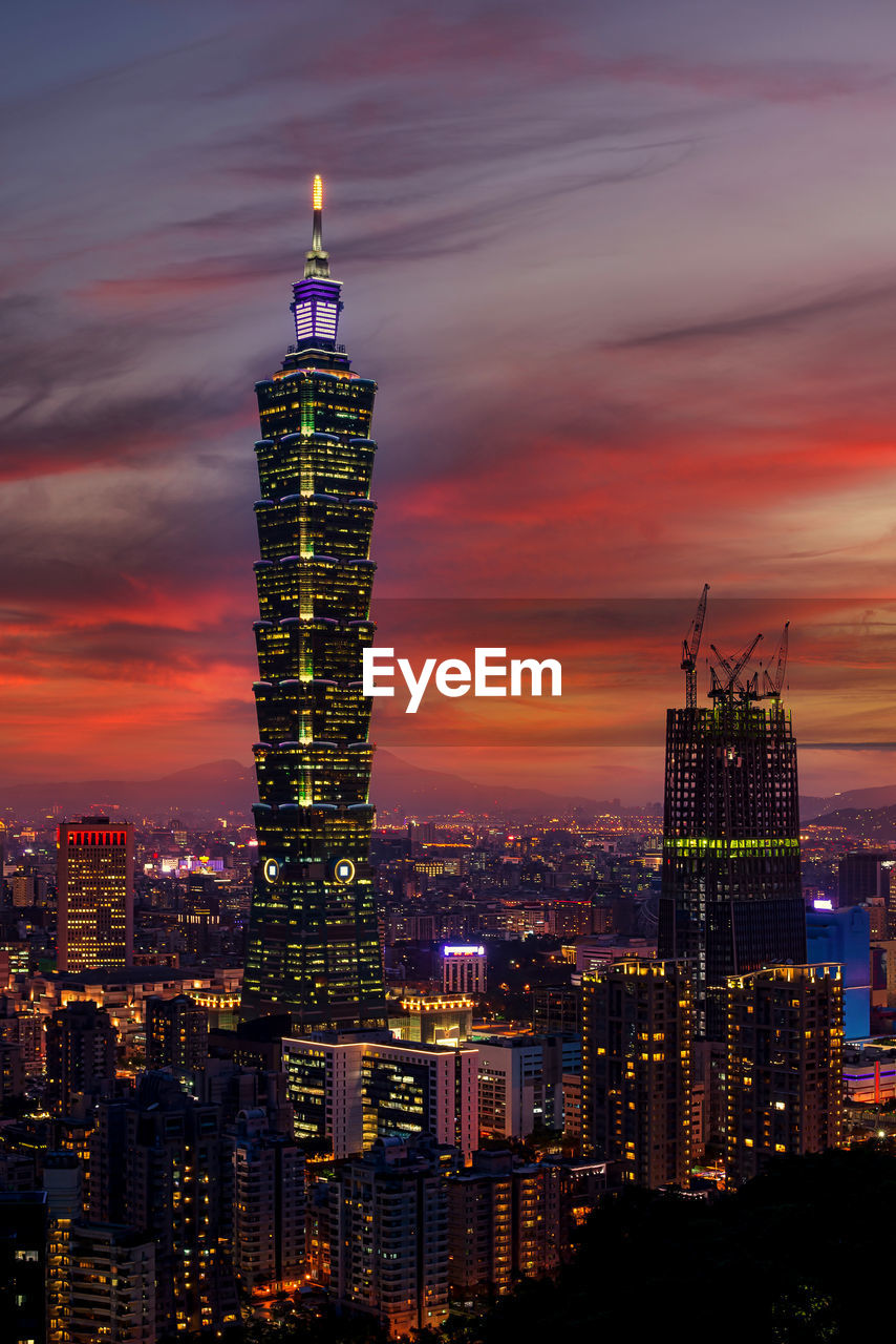 ILLUMINATED BUILDINGS AGAINST SKY AT SUNSET