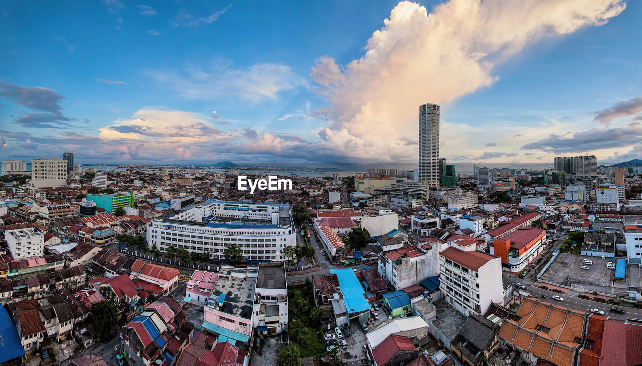 High angle view of cityscape against cloudy sky