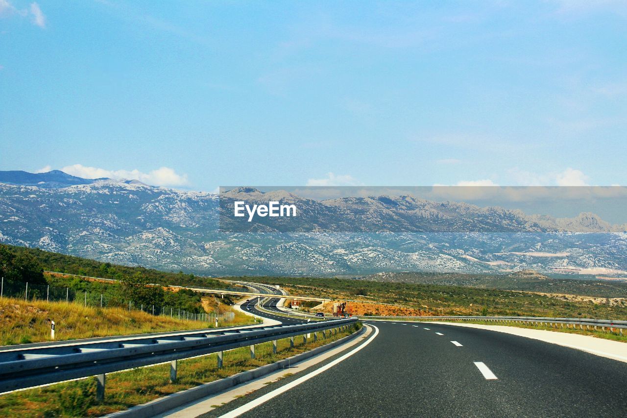 Country road leading towards mountains