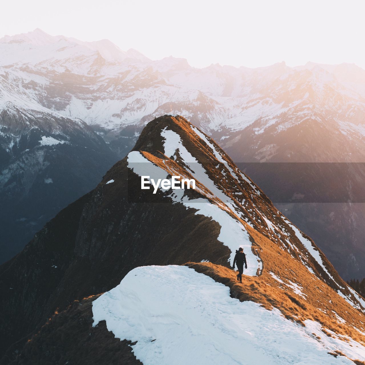 Person standing on snow covered mountain