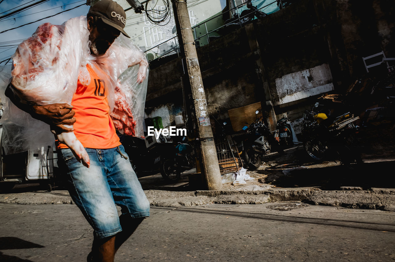 FULL LENGTH REAR VIEW OF MAN WORKING AT CONSTRUCTION SITE