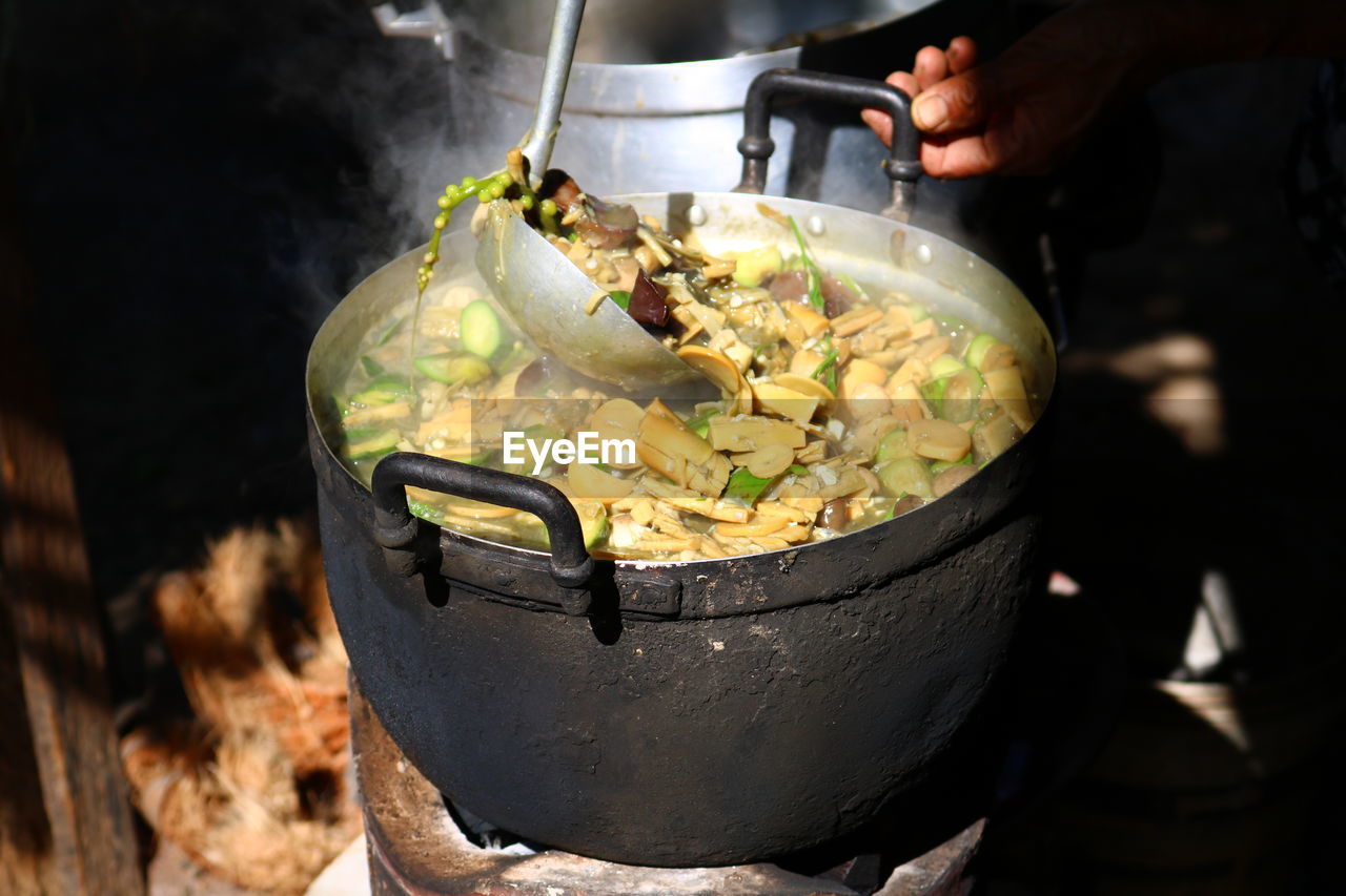 Close-up of human hand preparing food