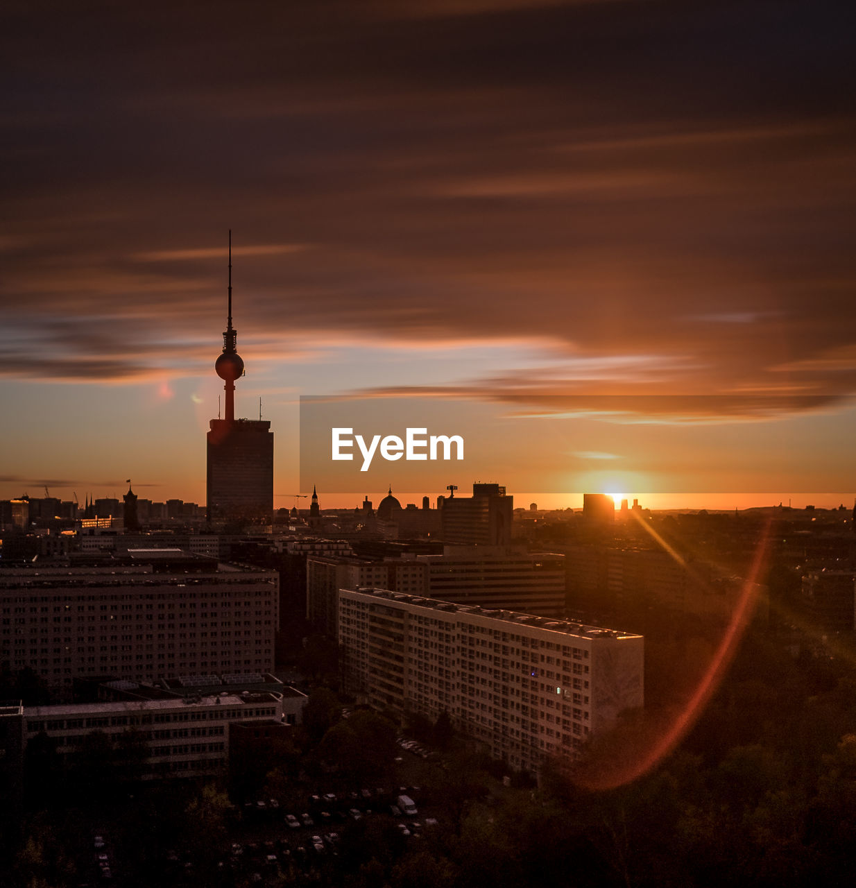 Buildings in city against sky during sunset