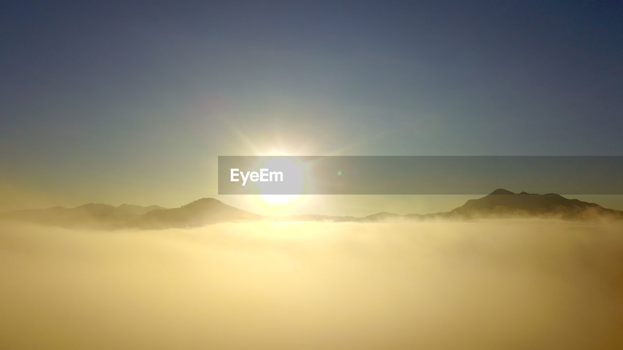 SCENIC VIEW OF MOUNTAIN RANGE AGAINST SKY DURING SUNSET