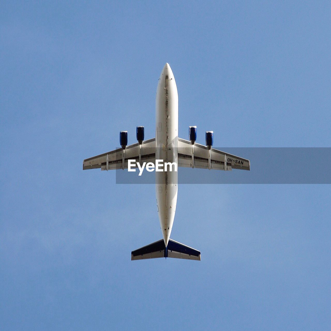 LOW ANGLE VIEW OF AIRPLANE FLYING IN SKY