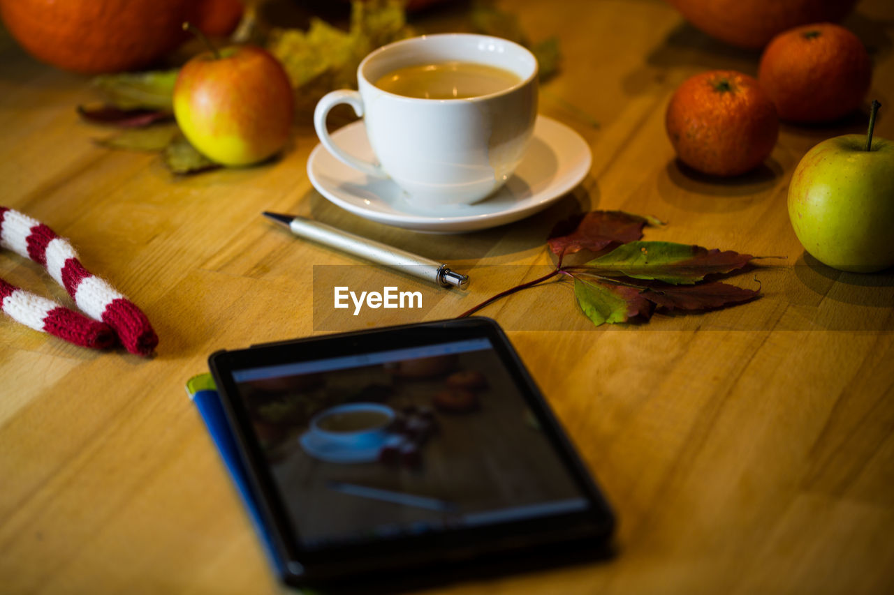 HIGH ANGLE VIEW OF FRUITS AND COFFEE ON TABLE AT HOME