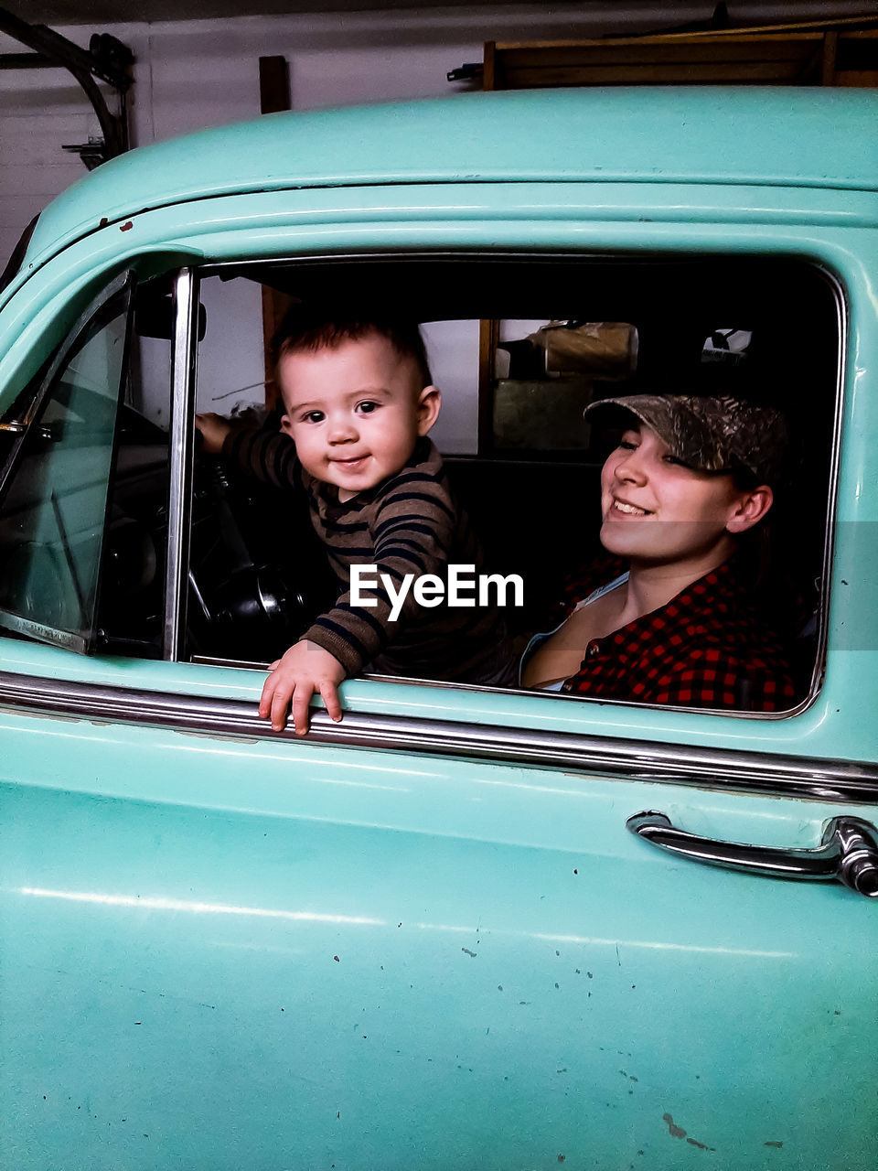 Portrait of a smiling mother and son in car