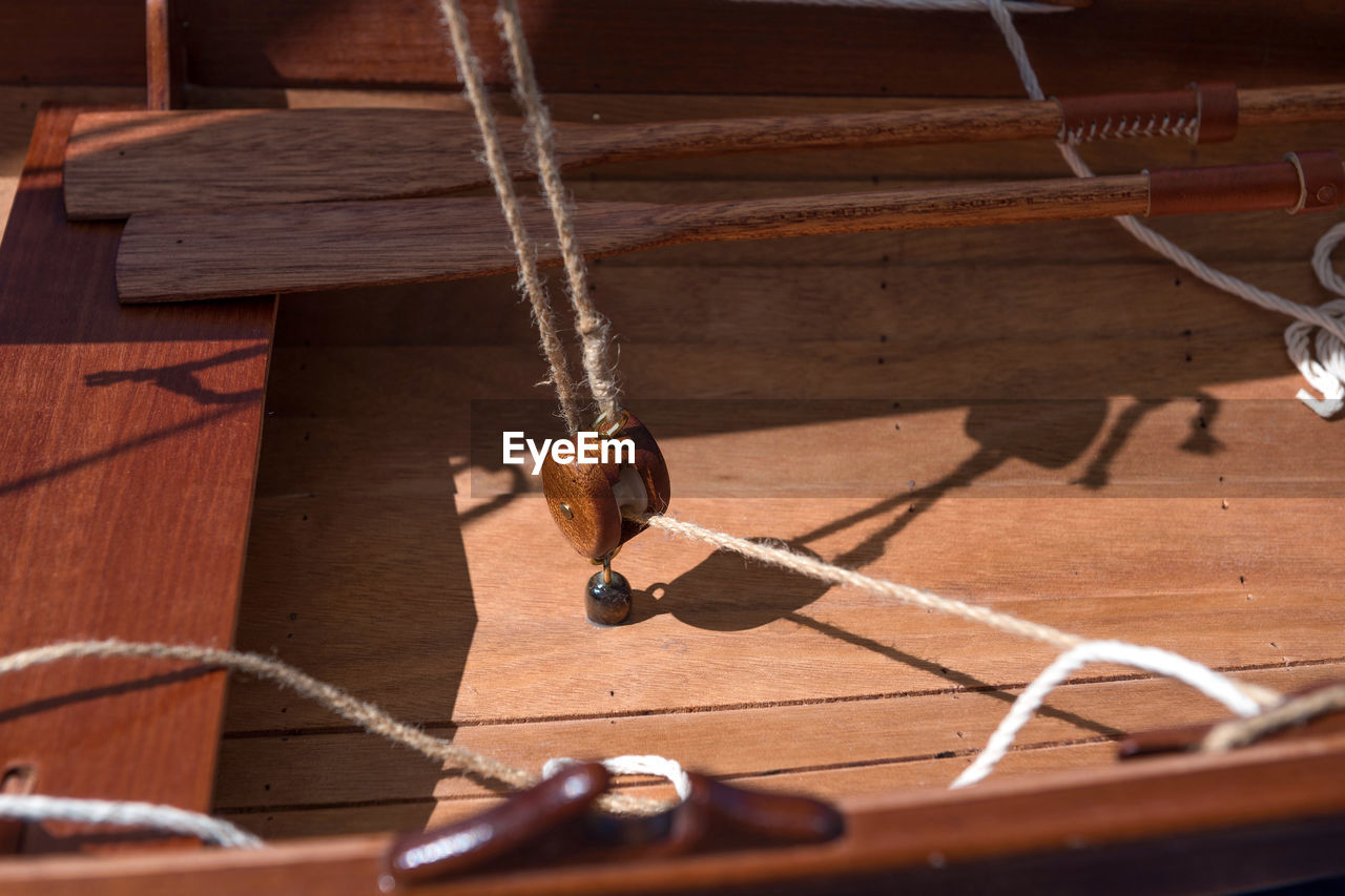 Old wooden sailboat pulleys and ropes detail