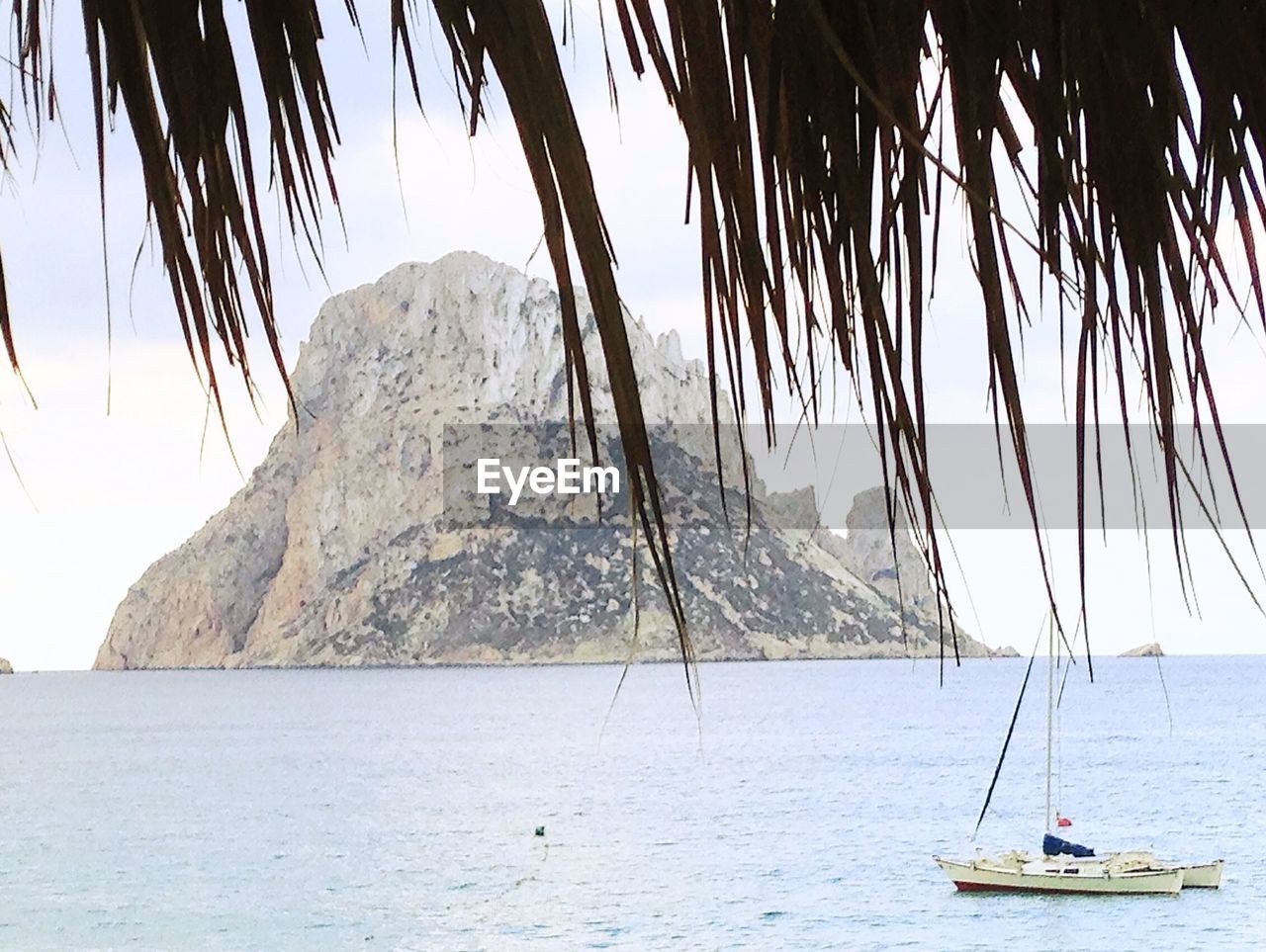 SCENIC VIEW OF SEA WITH MOUNTAINS IN BACKGROUND