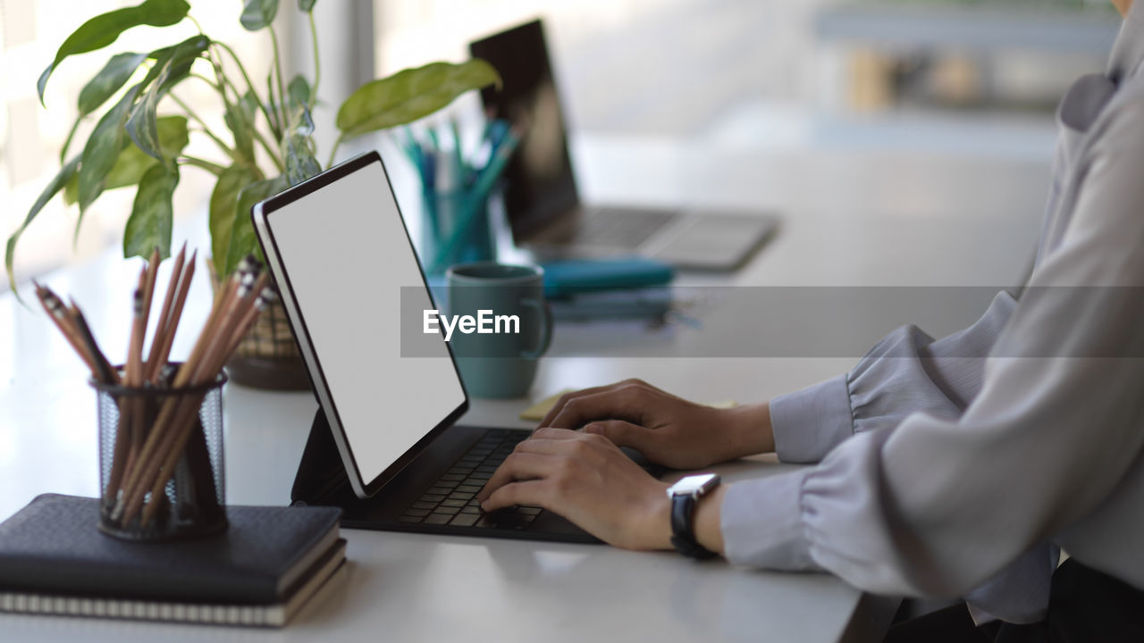 Low angle view of man using laptop on table