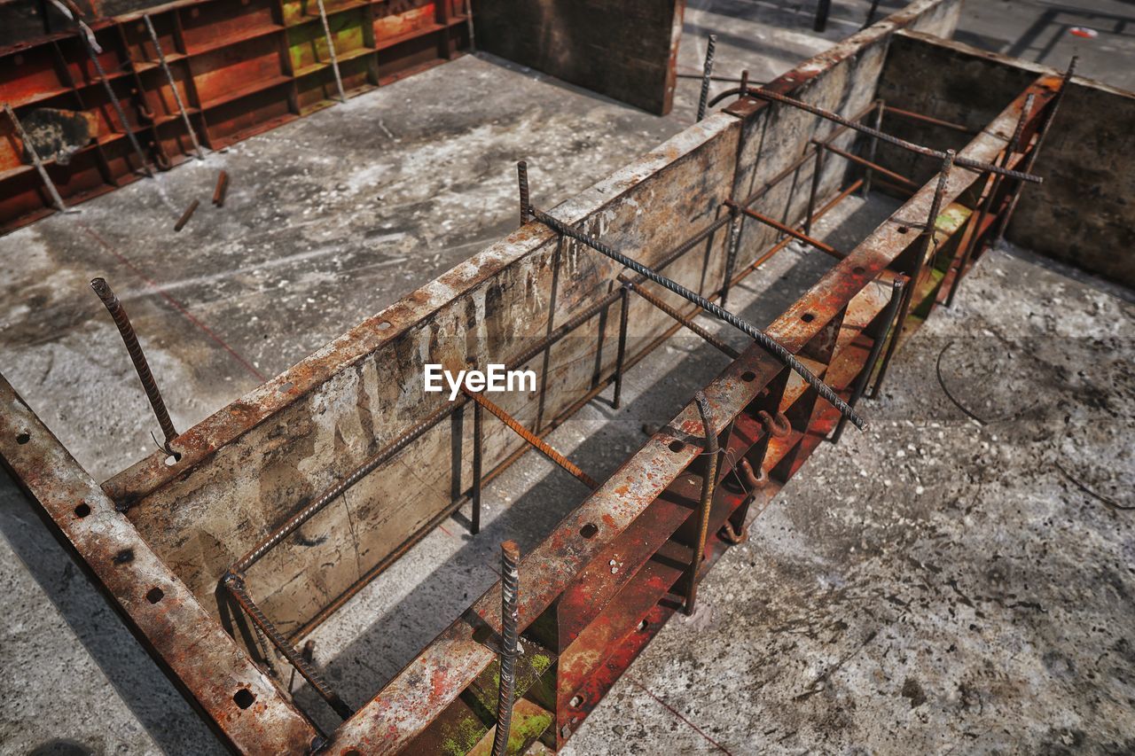 HIGH ANGLE VIEW OF CONSTRUCTION SITE BY ROAD