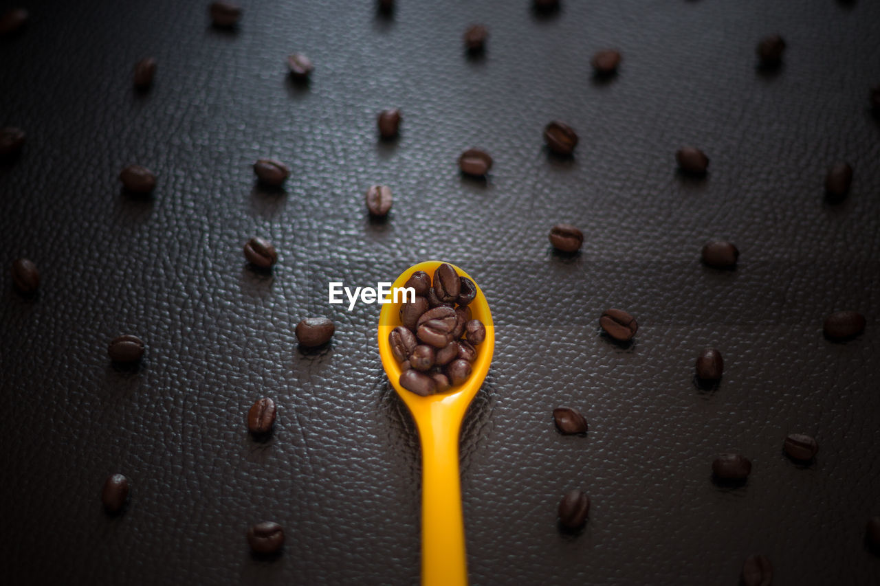 Full frame shot of roasted coffee beans on table