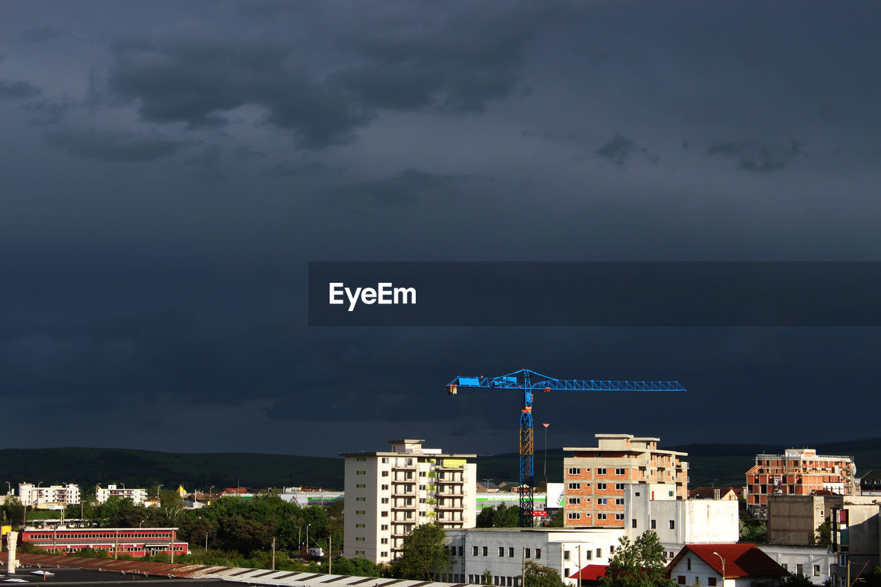 ILLUMINATED BUILDINGS IN CITY AGAINST SKY