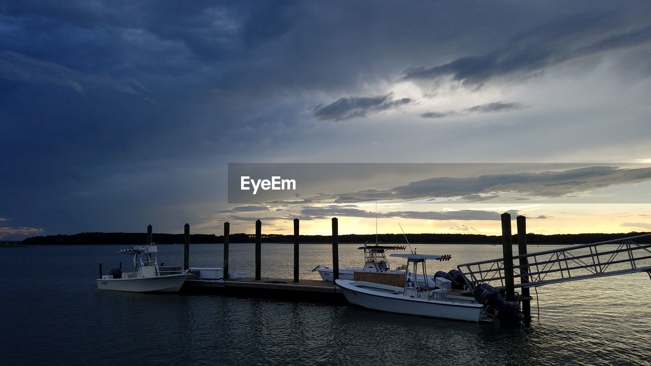 BOATS MOORED ON SEA