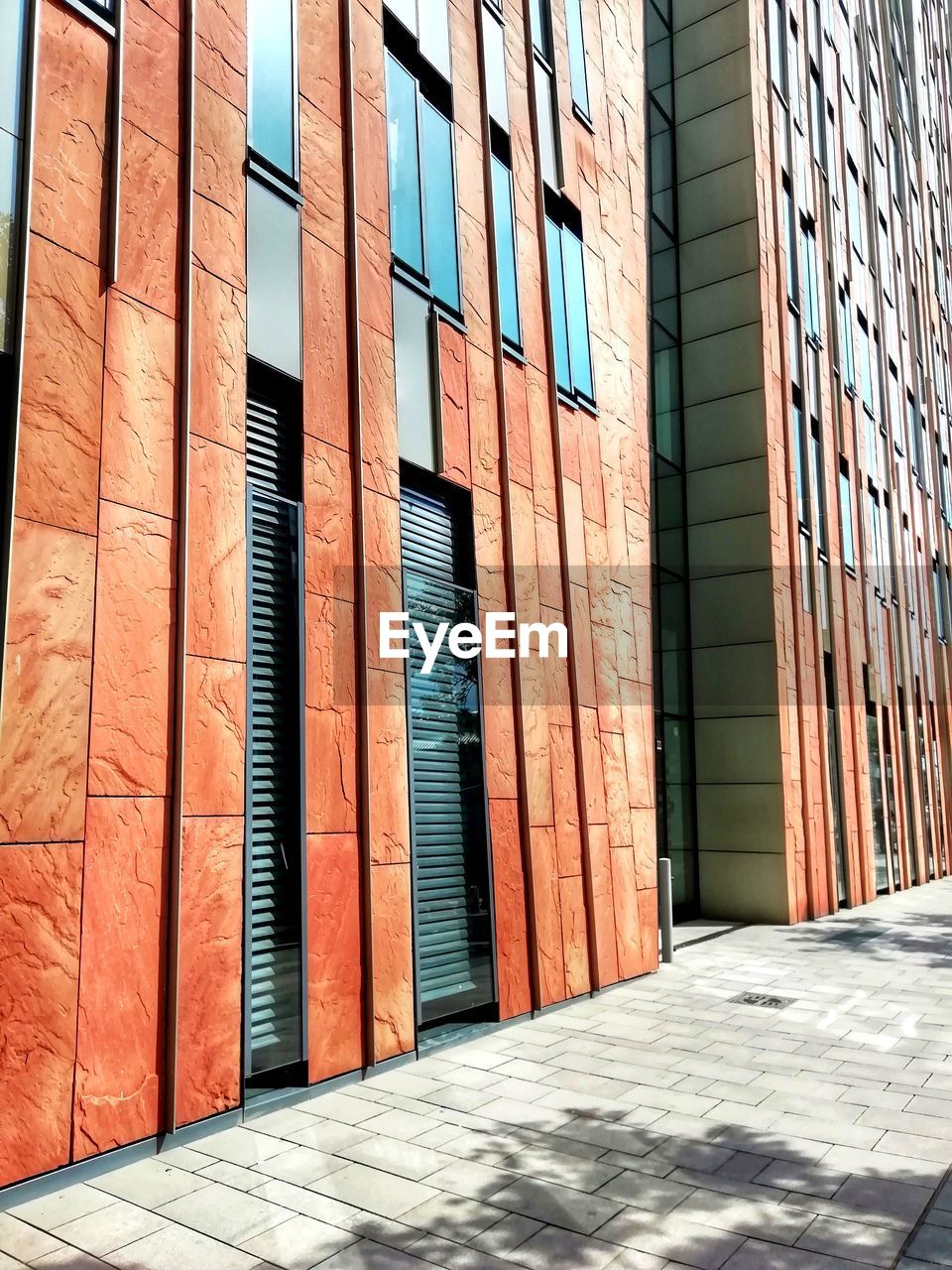 SUNLIGHT FALLING ON WALL BY BUILDING