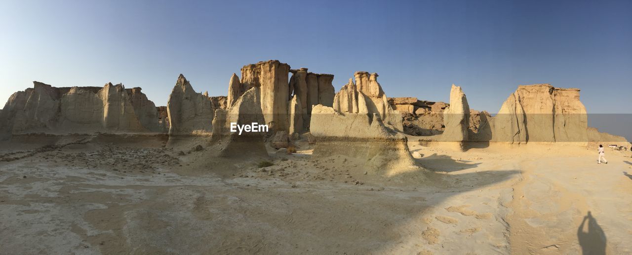 Panoramic view of desert against clear sky